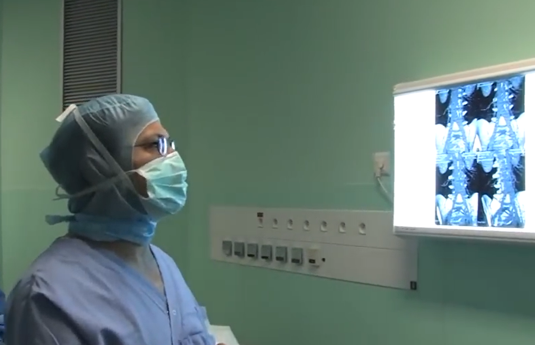 Neurochirurgien en bloc opératoire devant des images médicales